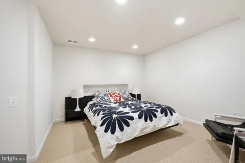 a bedroom with a bed and a chair