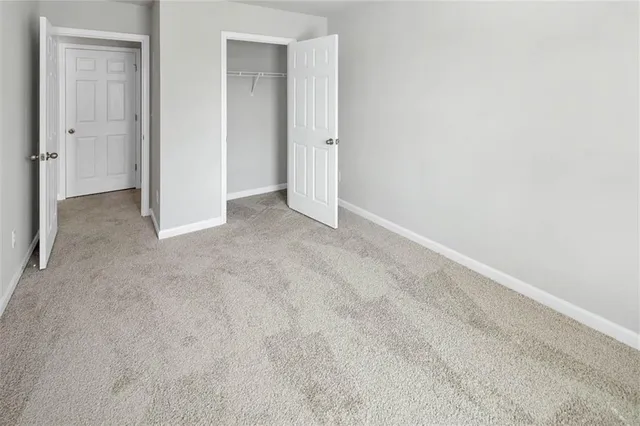 a view of an empty room and closet area