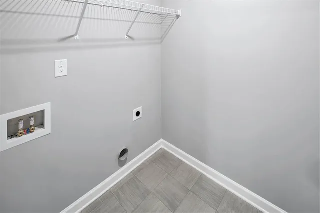 a front view of a house with a garden and trees