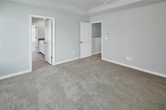 a view of an empty room and closet area
