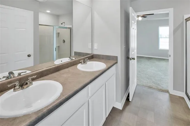 a bathroom with a sink double vanity and a mirror