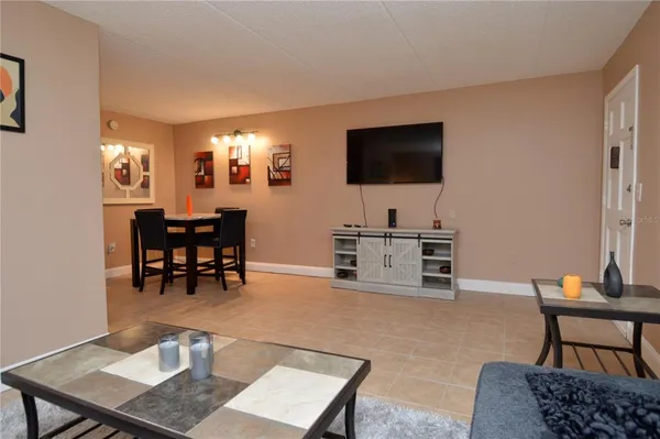 a view of a room with a table and chairs