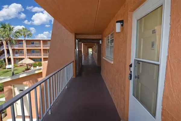 a kitchen with granite countertop a refrigerator and a sink