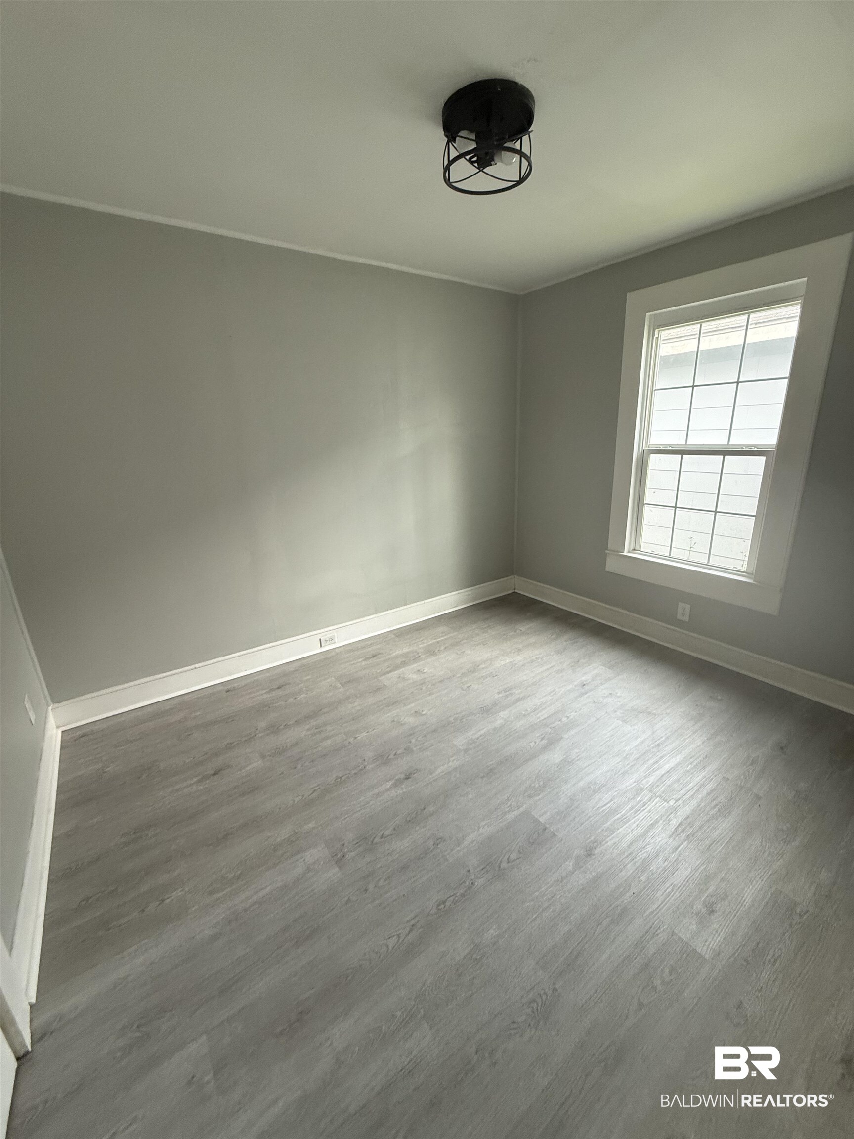 1848 Canal Street Mobile, AL 36606 - Photo 6 of 11 Spare room with baseboards and wood finished floors