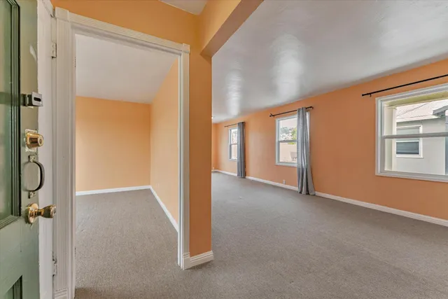 a view of a big room with windows and closet