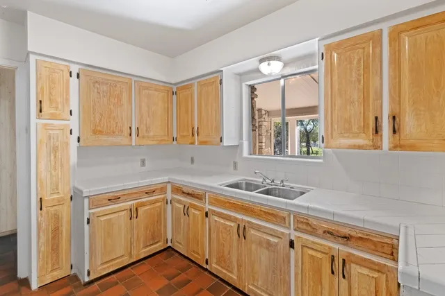 a kitchen with a sink stove and window