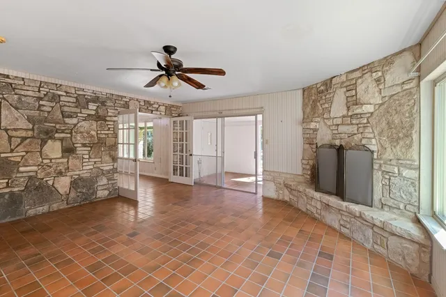 a view of a livingroom with wooden floor and a ceiling fan