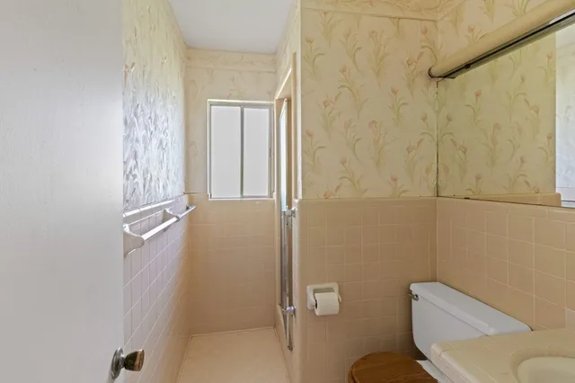 a bathroom with a toilet and a shower