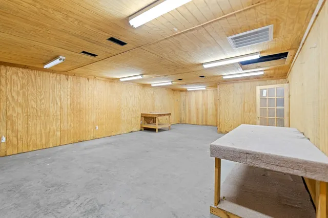 a hall with a cabinet and a refrigerator