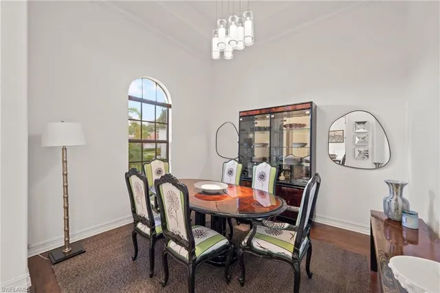 a view of a dining room with furniture and chandelier