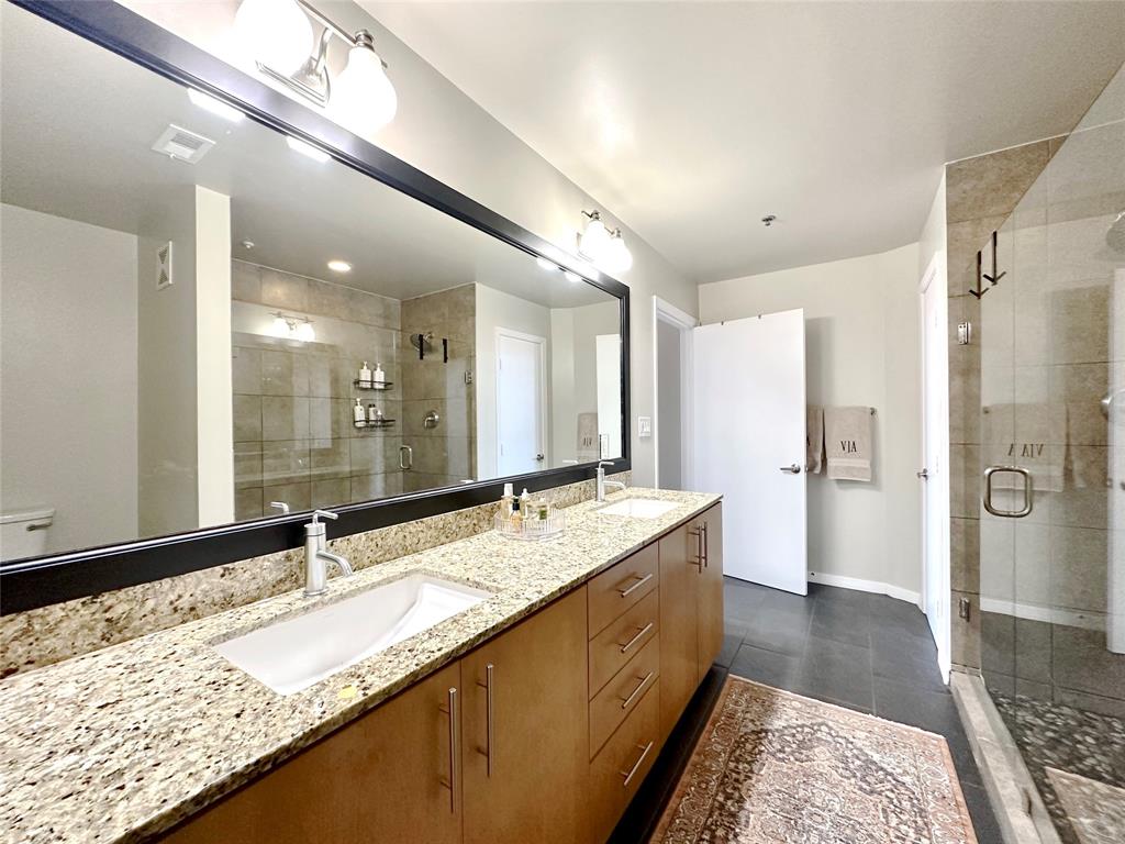 1001 Belleview Street, Unit 307 Dallas, TX 75215 - Photo 26 of 36 New comfort height toilet, siate look tile, and linencloset for a bathroom to LOVE!