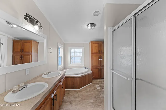 a bathroom with a tub sink and mirror