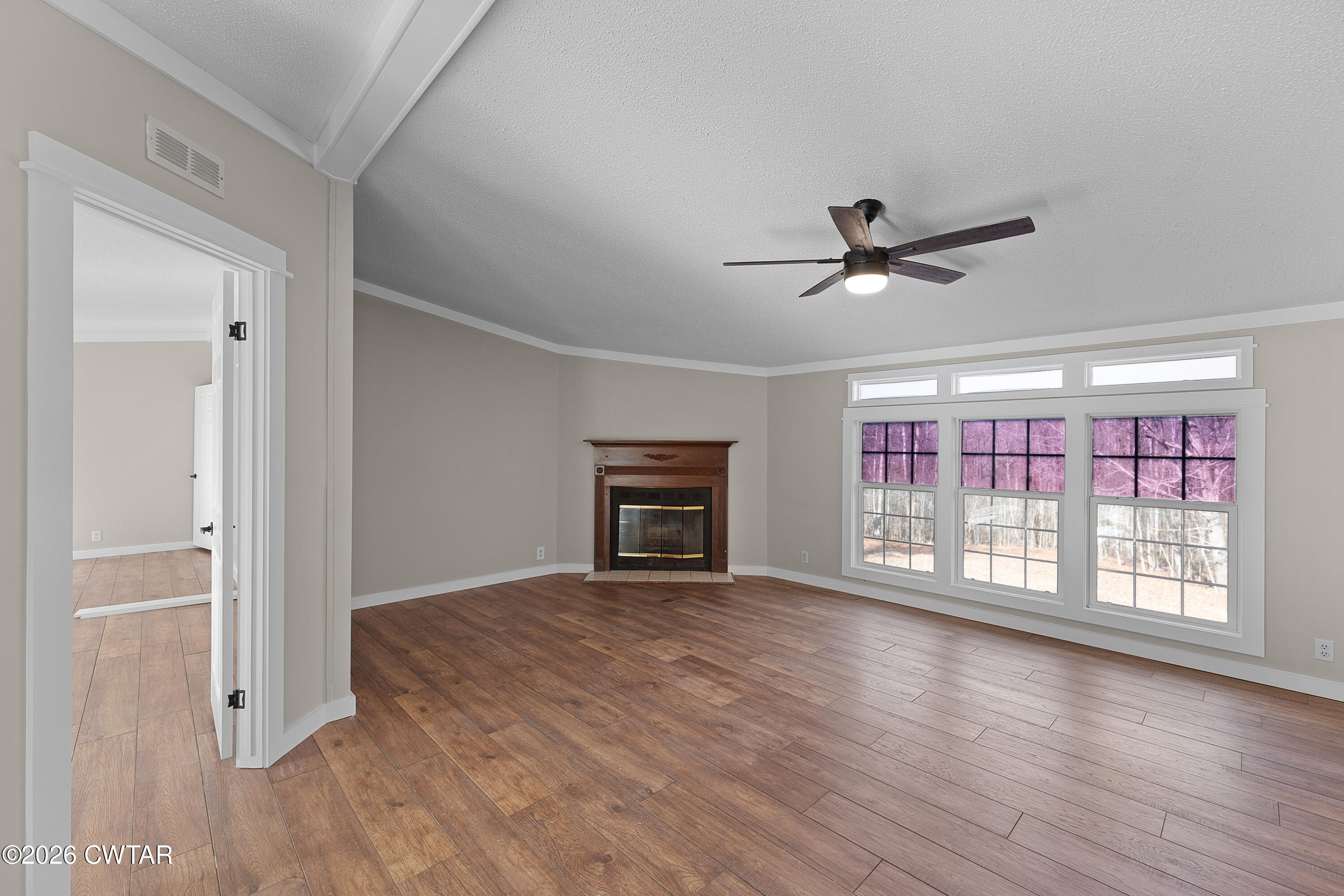 1920 Parkburg Road Medon, TN 38356 - Photo 5 of 17 a view of an empty room with a window and wooden floor