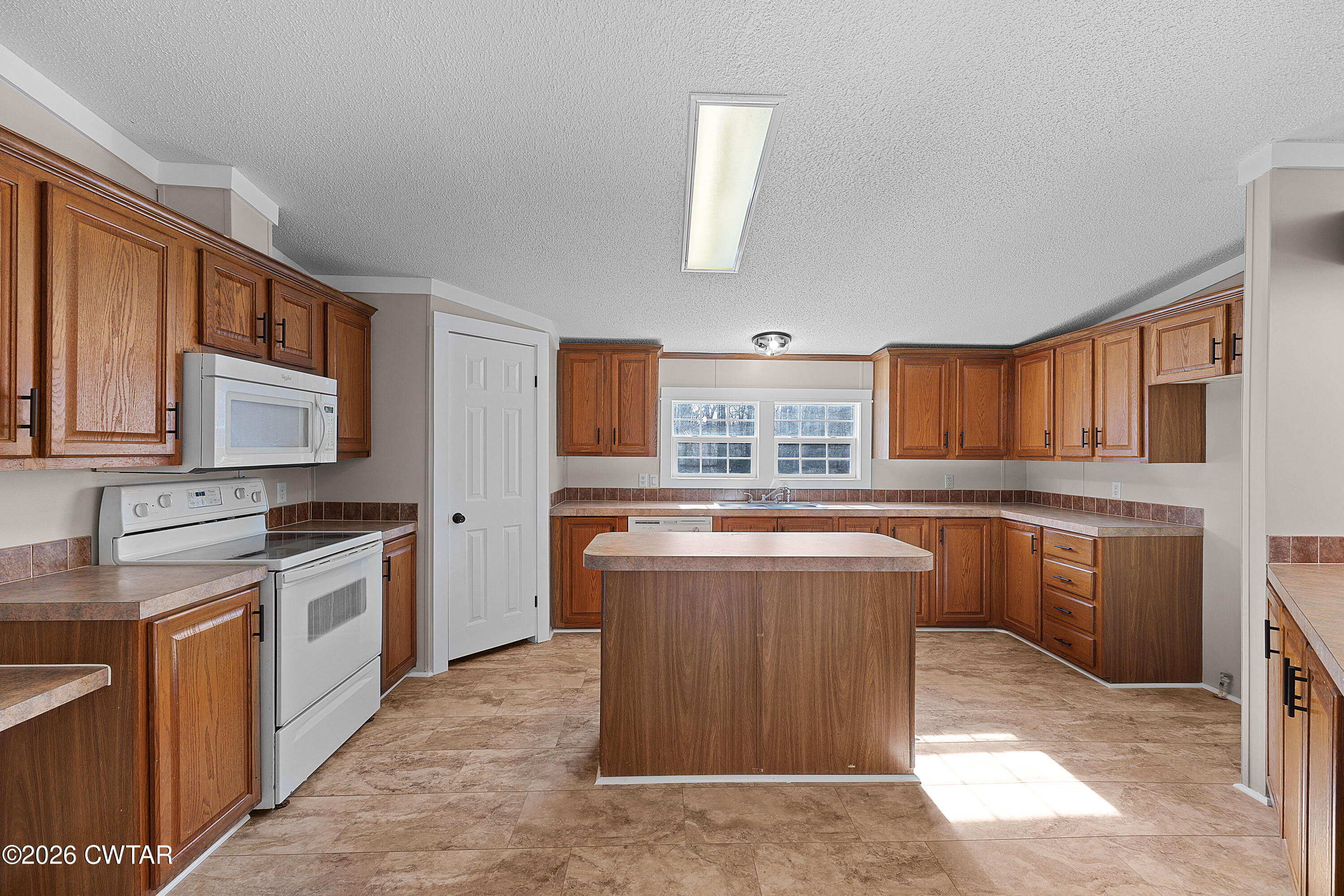 1920 Parkburg Road Medon, TN 38356 - Photo 8 of 17 a kitchen with stainless steel appliances granite countertop a stove a sink dishwasher and a refrigerator