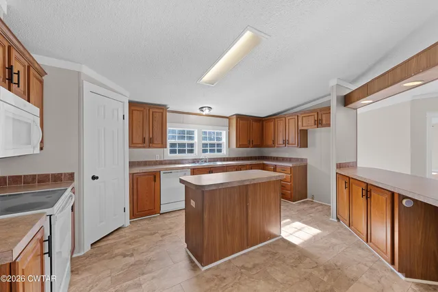 a kitchen with a stove a refrigerator and a sink