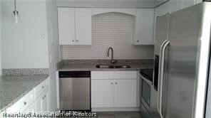 357 US Highway 27 South Sebring, FL 33870 - Photo 4 of 10 a kitchen with stainless steel appliances granite countertop a refrigerator and a sink