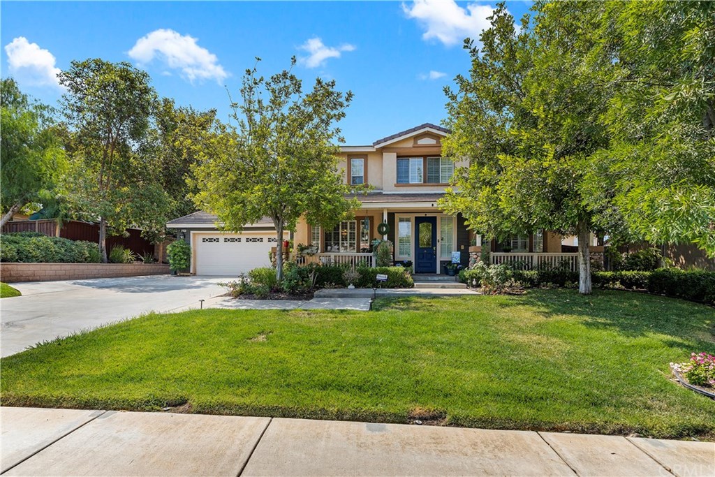 a front view of a house with patio and garden