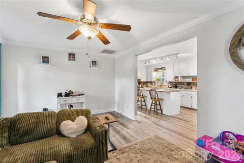 a living room with furniture and a dining table