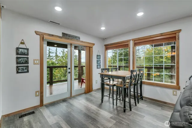 a view of a dining room with furniture window and wooden floor