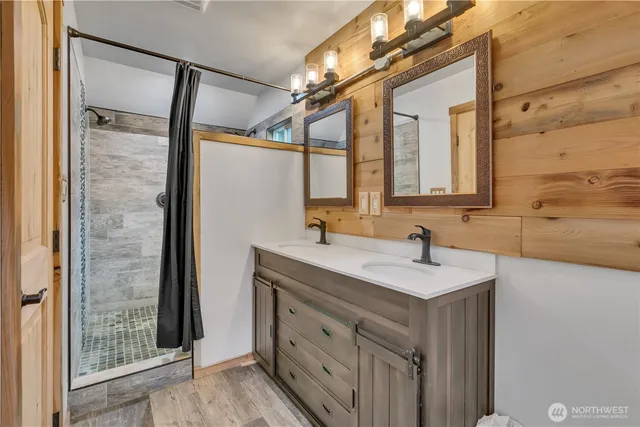 a bathroom with a sink a mirror and a shower