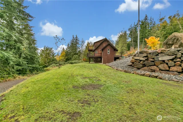 a view of a house with a yard and potted plants