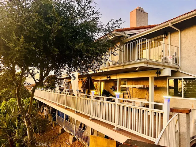 a view of a balcony with wooden floor and outdoor space