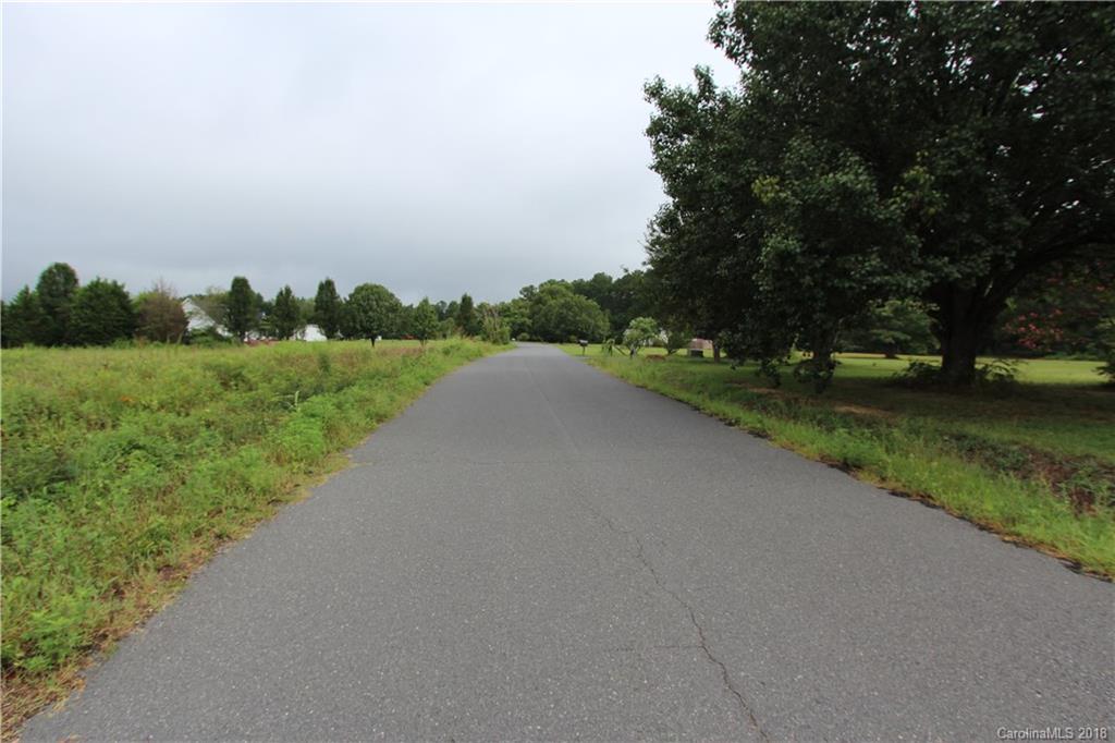 2938 Southeastern Road, Unit 13 Rock Hill, SC 29730 - Photo 3 of 21 a view of a road with a yard and large trees
