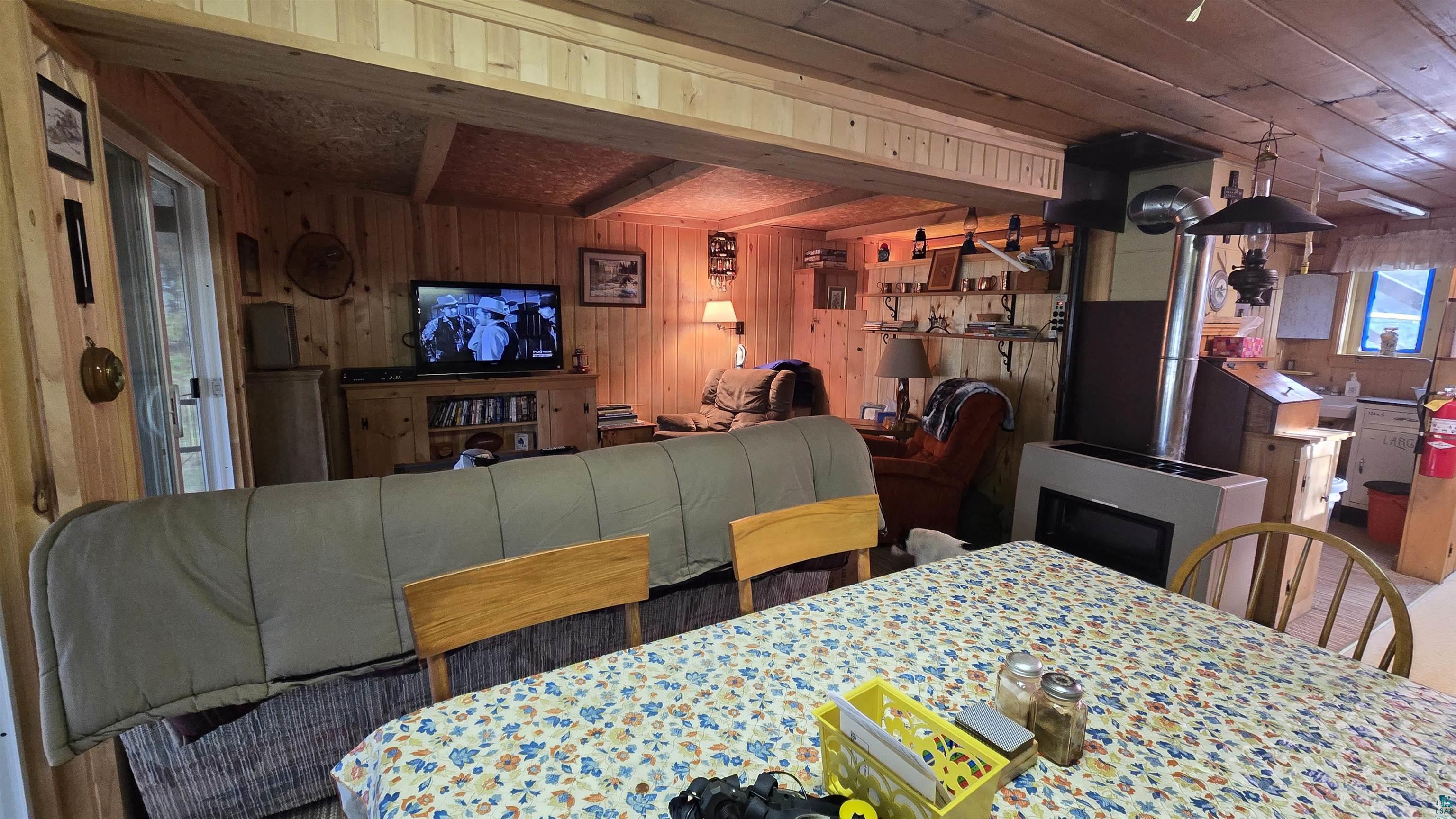 7178 Gold Mine Road Orr, MN 55771 - Photo 20 of 36 Dining room with wooden walls and beamed ceiling