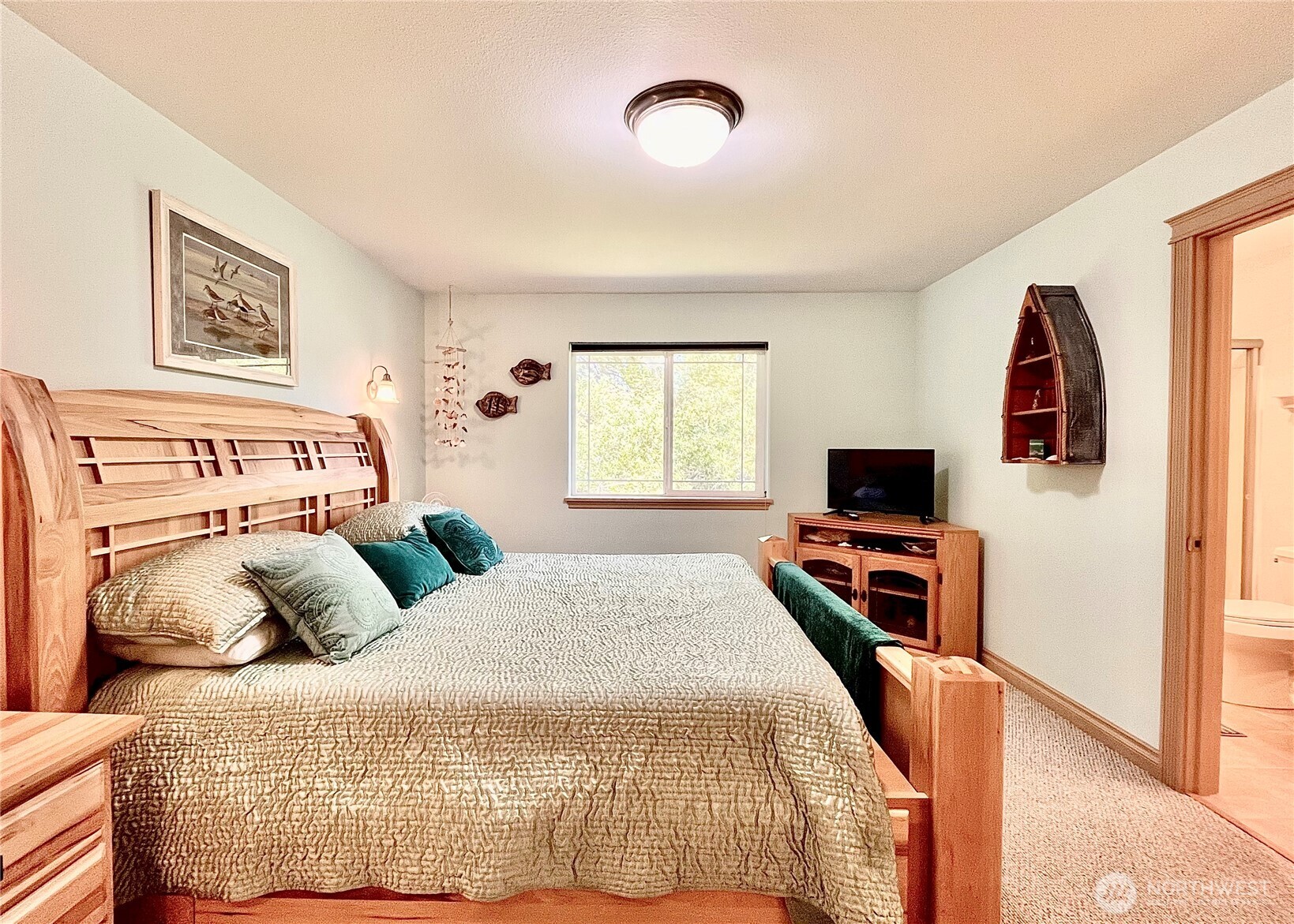 137 North Razor Clam Drive Southwest Ocean Shores, WA 98569 - Photo 10 of 31 a bedroom with a bed and a flat screen tv