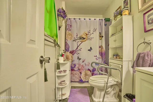 a white toilet sitting next to a bathroom sink