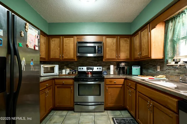a kitchen with a sink and a refrigerator
