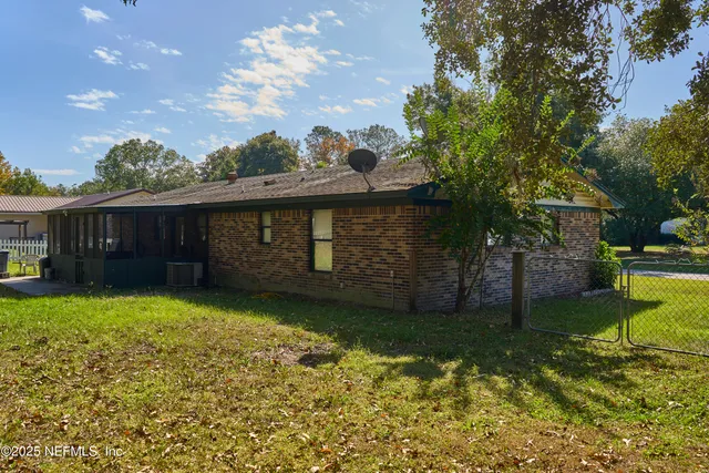 a view of a yard with plants and trees