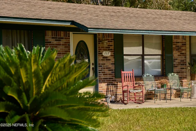 a front view of house with a garden