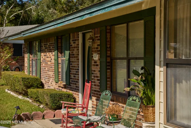 a front view of a house with plants