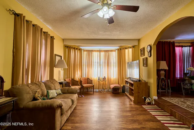 a living room with furniture and large windows