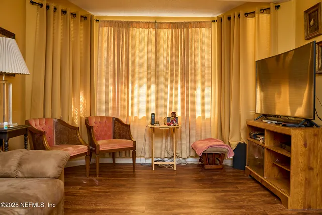 a living room with furniture and a flat screen tv