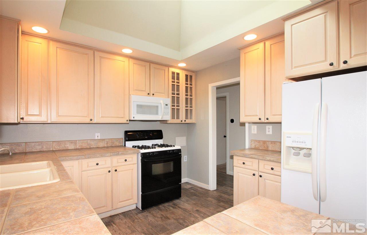 1280 Tacoma Way Reno, NV 89509 - Photo 7 of 36 a kitchen with stainless steel appliances granite countertop a stove a sink and a refrigerator