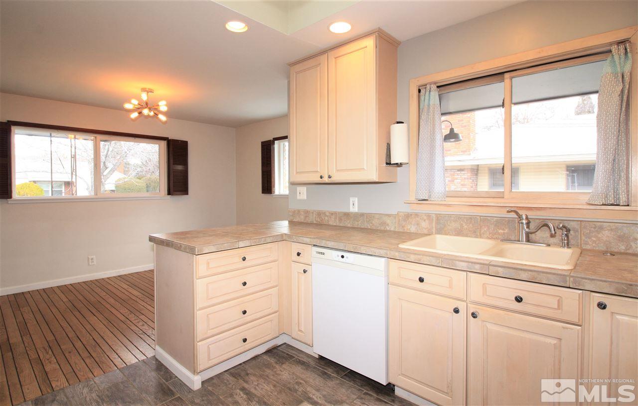 1280 Tacoma Way Reno, NV 89509 - Photo 8 of 36 a kitchen with granite countertop white cabinets and a window