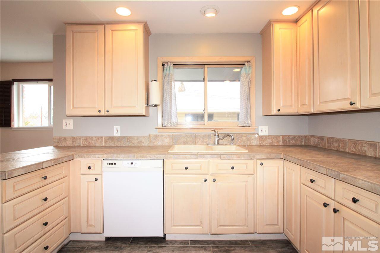 1280 Tacoma Way Reno, NV 89509 - Photo 9 of 36 a kitchen with granite countertop white cabinets and sink