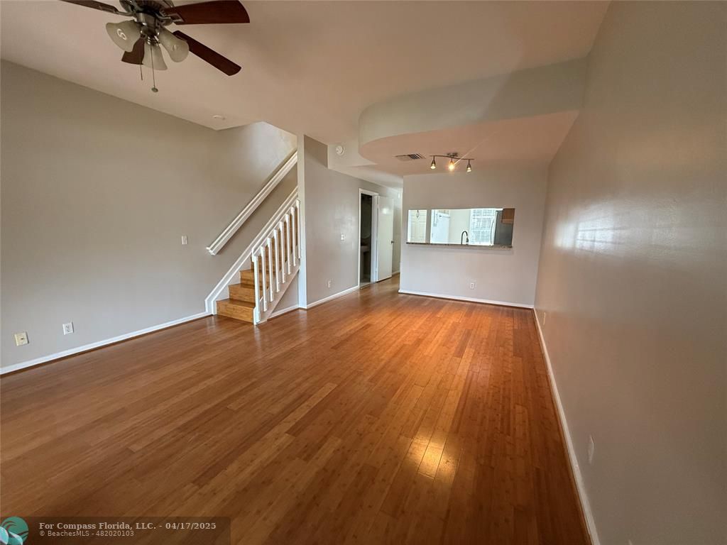 5295 Jamboree Place Margate, FL 33063 - Photo 13 of 35 a view of an empty room with a window and wooden floor