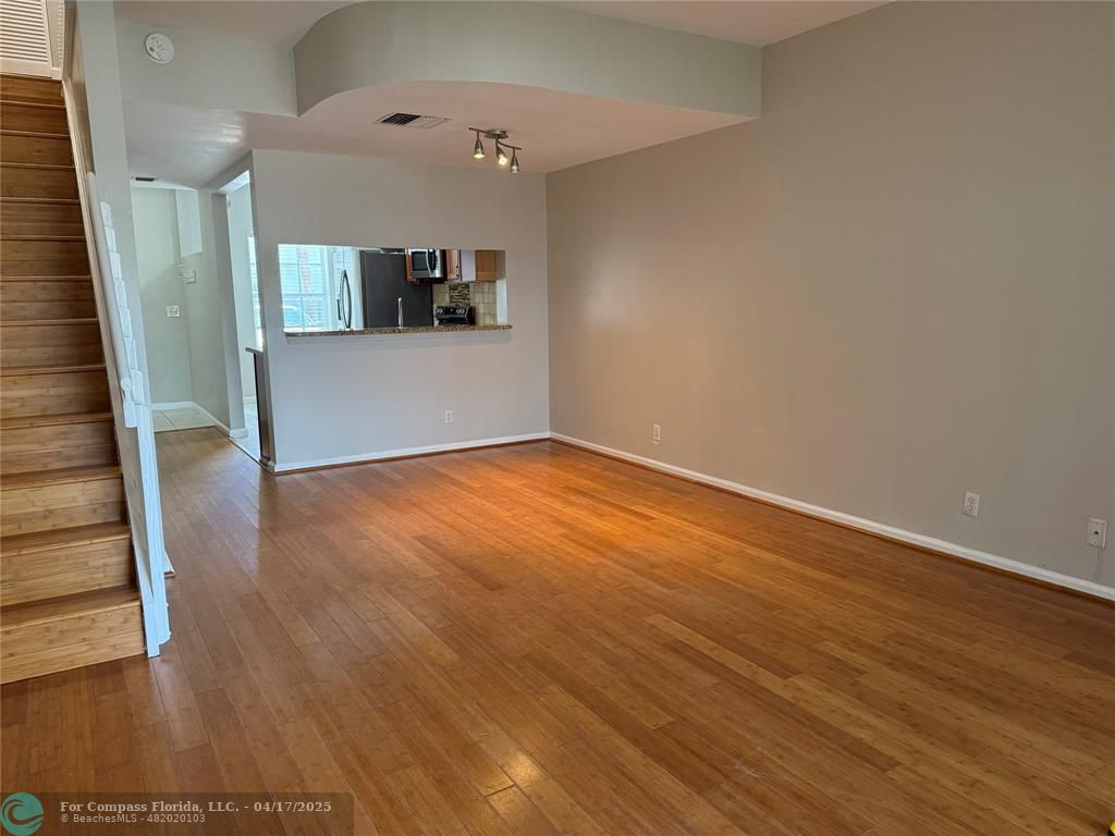 5295 Jamboree Place Margate, FL 33063 - Photo 14 of 35 wooden floor in an empty room with a window