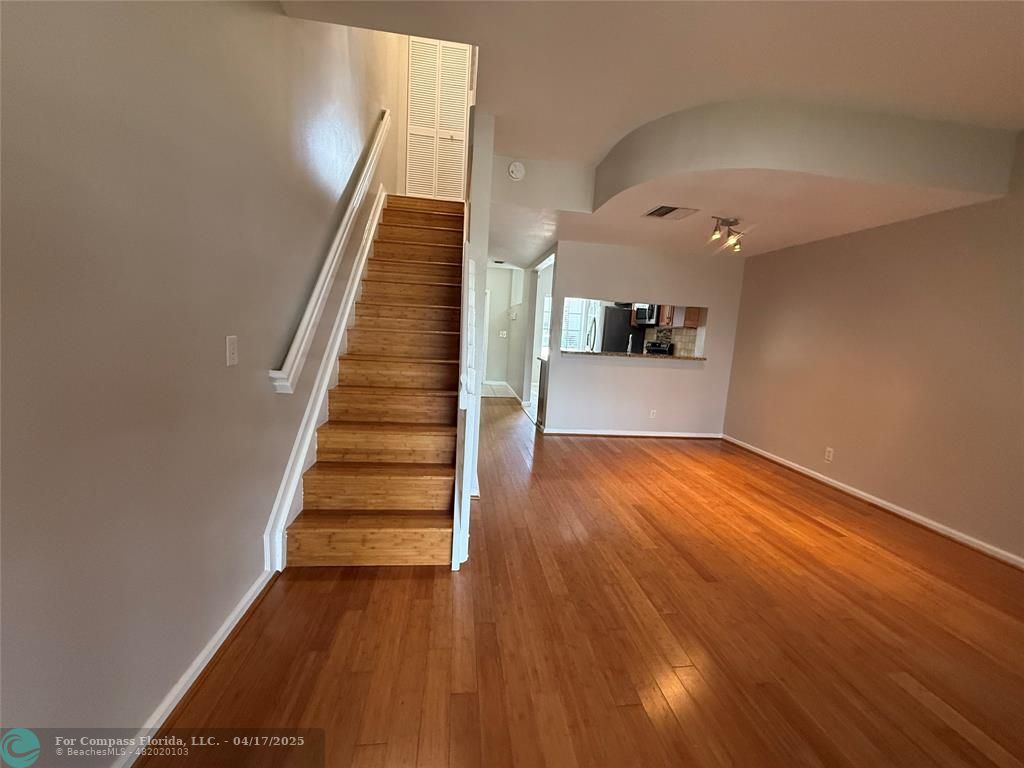 5295 Jamboree Place Margate, FL 33063 - Photo 17 of 35 wooden floor in an empty room with stairs