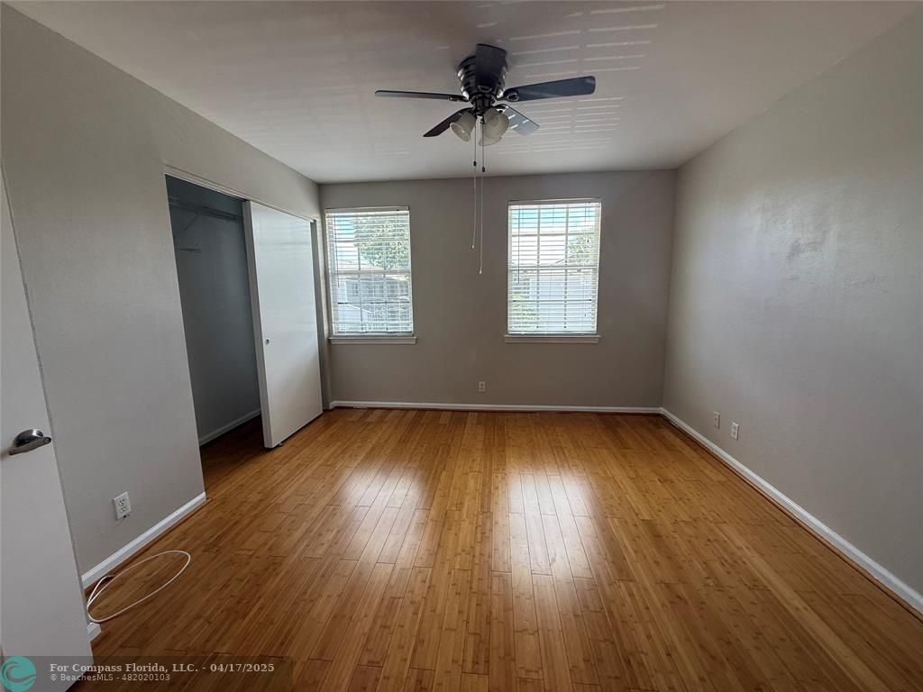 5295 Jamboree Place Margate, FL 33063 - Photo 18 of 35 an empty room with wooden floor and windows