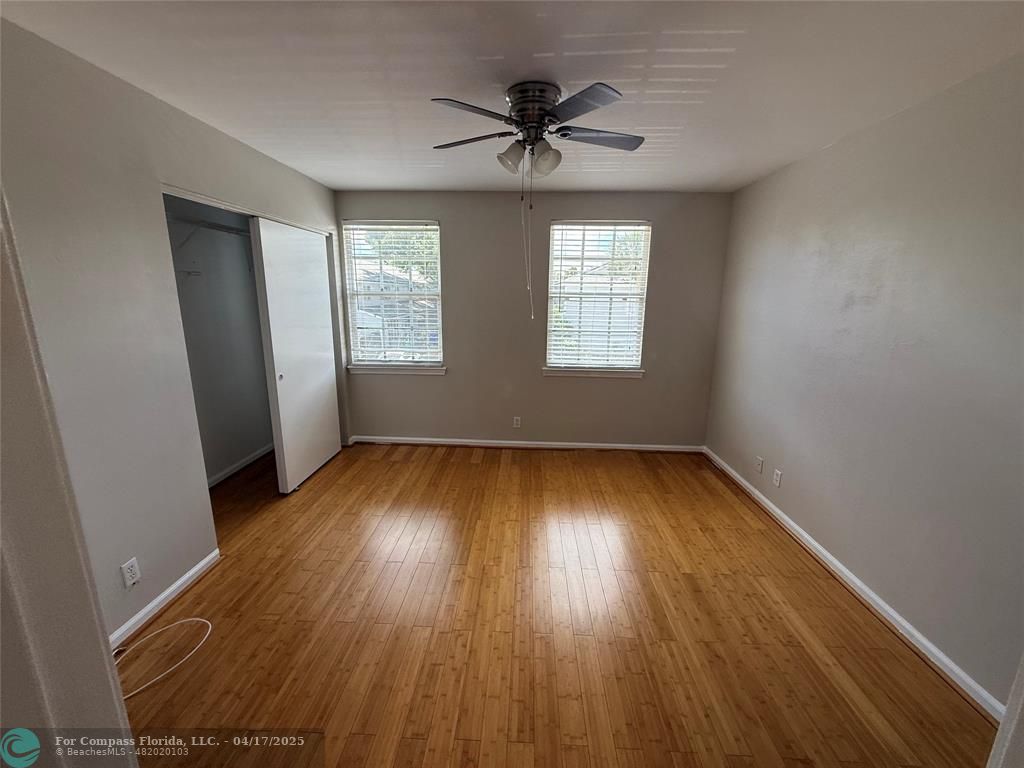 5295 Jamboree Place Margate, FL 33063 - Photo 20 of 35 an empty room with wooden floor and windows