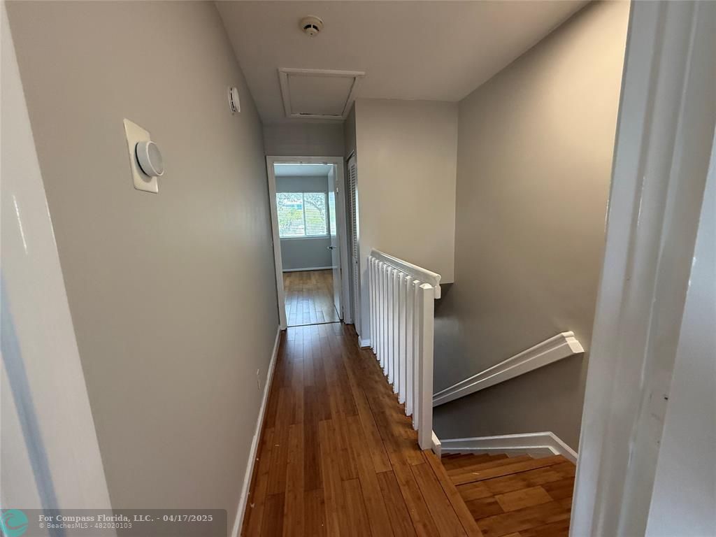 5295 Jamboree Place Margate, FL 33063 - Photo 23 of 35 a view of a hallway with wooden floor and staircase