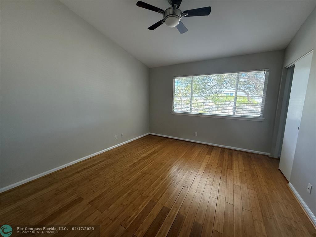 5295 Jamboree Place Margate, FL 33063 - Photo 24 of 35 an empty room with wooden floor fan and windows