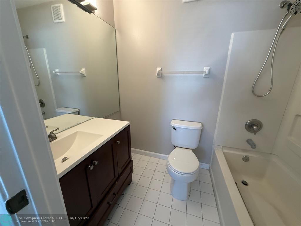 5295 Jamboree Place Margate, FL 33063 - Photo 25 of 35 a bathroom with a sink a toilet and a mirror