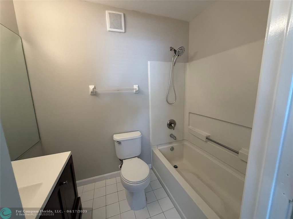 5295 Jamboree Place Margate, FL 33063 - Photo 26 of 35 a bathroom with a granite countertop toilet and a shower