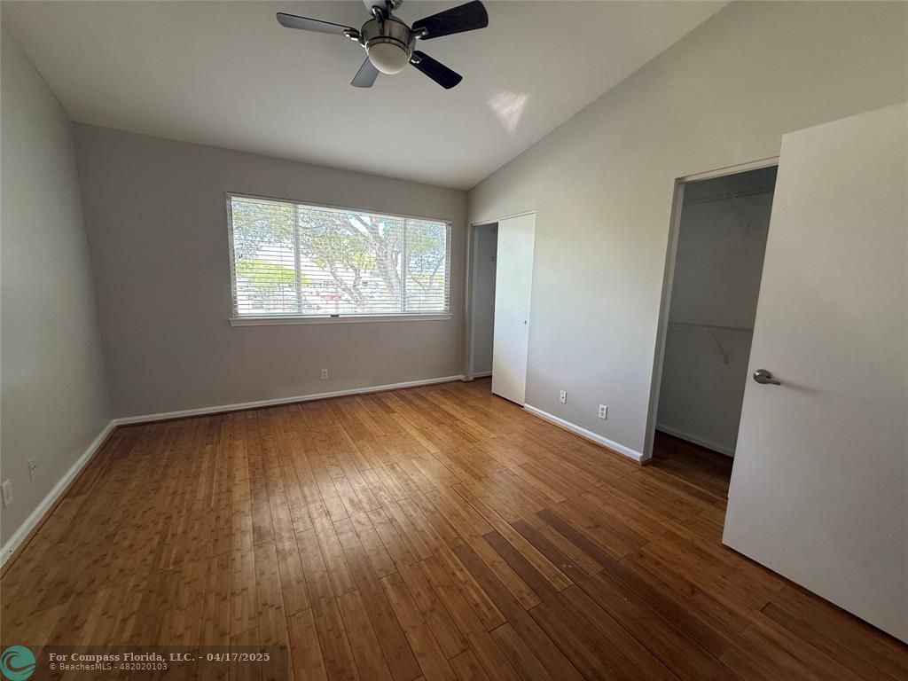 5295 Jamboree Place Margate, FL 33063 - Photo 27 of 35 an empty room with wooden floor fan and windows