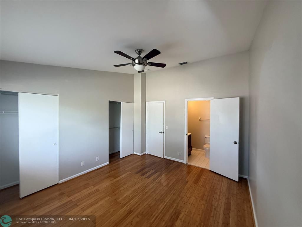 5295 Jamboree Place Margate, FL 33063 - Photo 30 of 35 a view of a big room with wooden floor and a ceiling fan